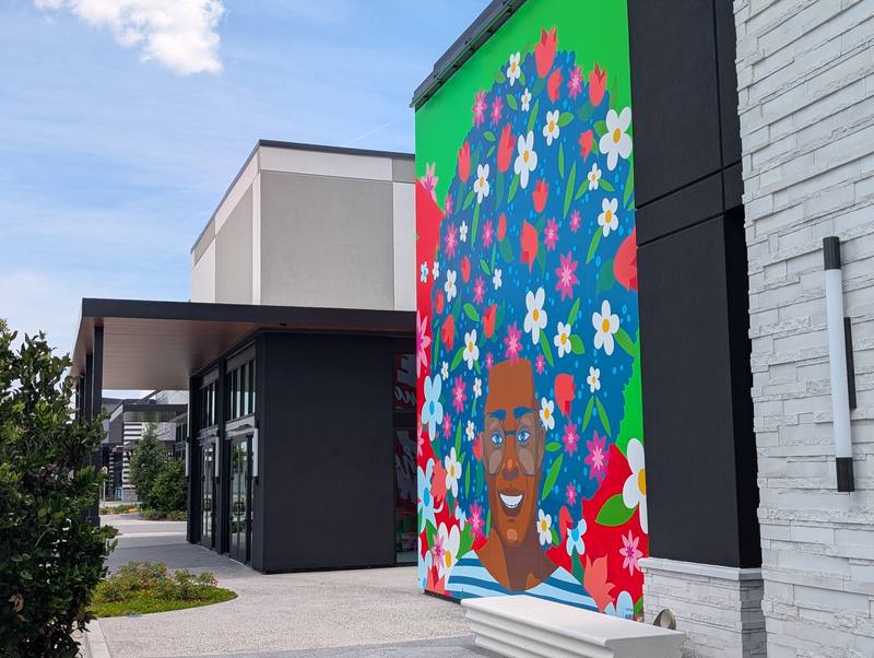 Colorful floral portrait mural in a Lake Nona retail district