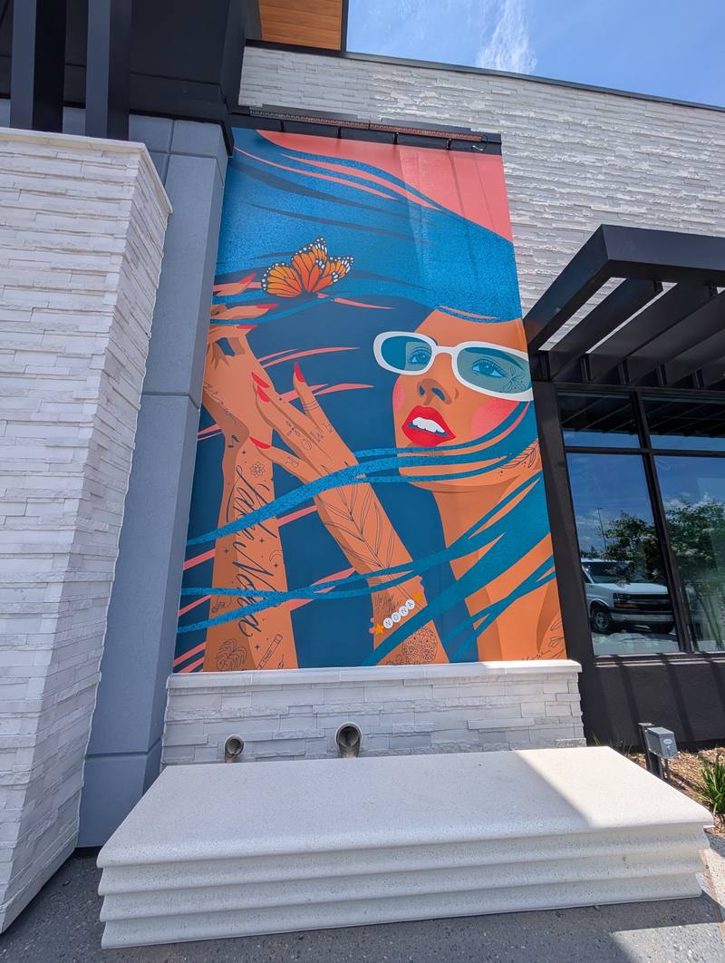 Lake Nona mural with blue-haired woman and butterfly